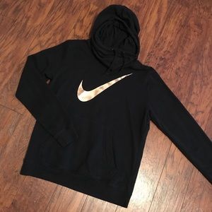 Nike hoodie. Gold Nike sign.